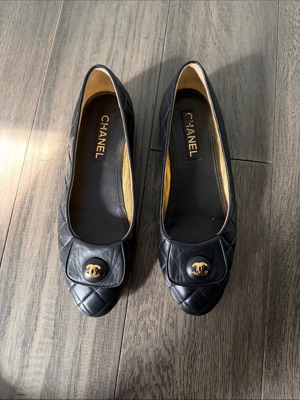 CHANEL Black Quilted Leather Flats with Gold CC Medallion